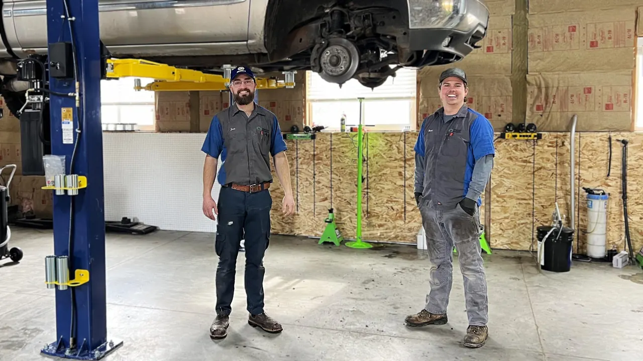 Green Light Automotive technicians in the Rexburg repair shop with a truck on a lift
